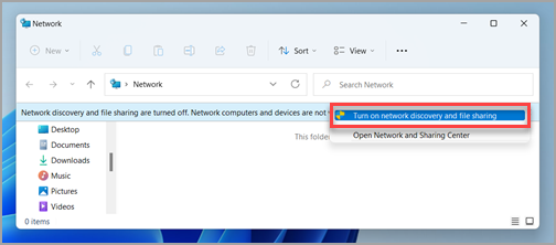 Windows 11 File Explorer showing the Turn on network discovery and file sharing command
